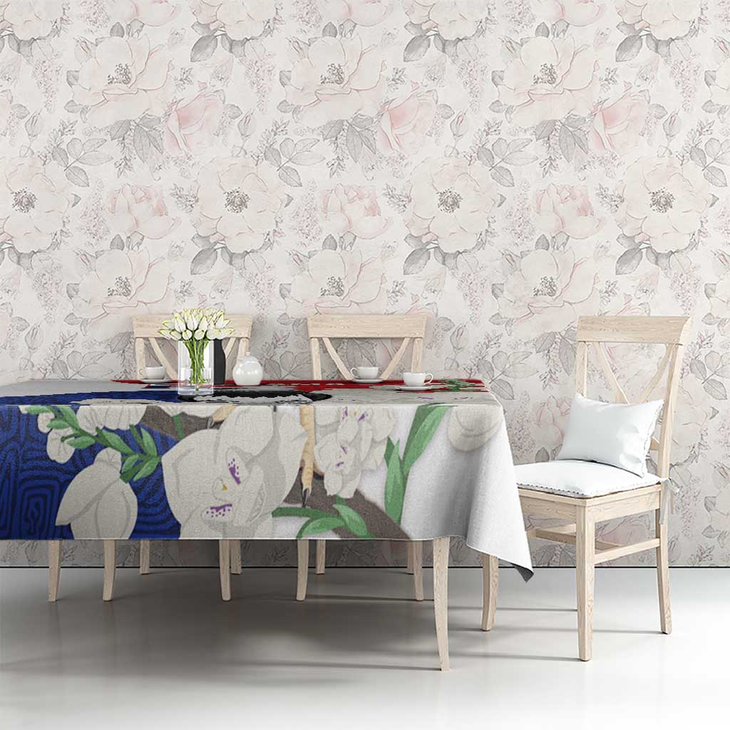 Harpy eagle mola-pattern tablecloth in red and blue on dining table, full view