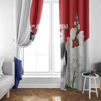 Flag-style harpy eagle window curtain panels by window, showing red, blue, and white prints.