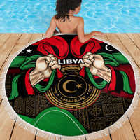 Round Libya beach blanket with white fringe, “LIBYA” emblem, flag colors and central star