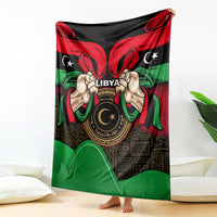 Libya flag-style blanket with 'LIBYA' text and hands holding circular emblem