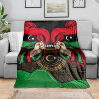 Libya flag-style blanket featuring hands, 'LIBYA' lettering, and circular emblem design