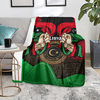 Libya flag-style blanket with bold hands, 'LIBYA' text, and circular emblem centerpiece