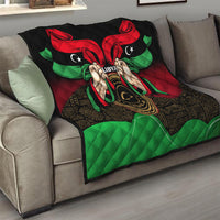 Libya flag-style quilt on couch with red wing shapes, green accents, and hands emblem.