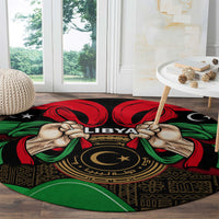 Round black rug with centered LIBYA text, raised hands, and red-green flag pattern