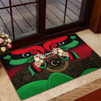 Black rubber doormat with Libya seal, holding-hands artwork, and red-green ribbon flag