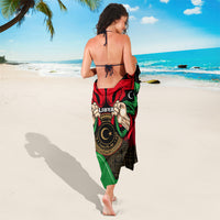 Black sarong with “LIBYA” text, red and green flag design, crescent stars and emblem