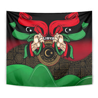 Square wall tapestry with black background, red ribbon wings, green accents, Libya emblem and hands.