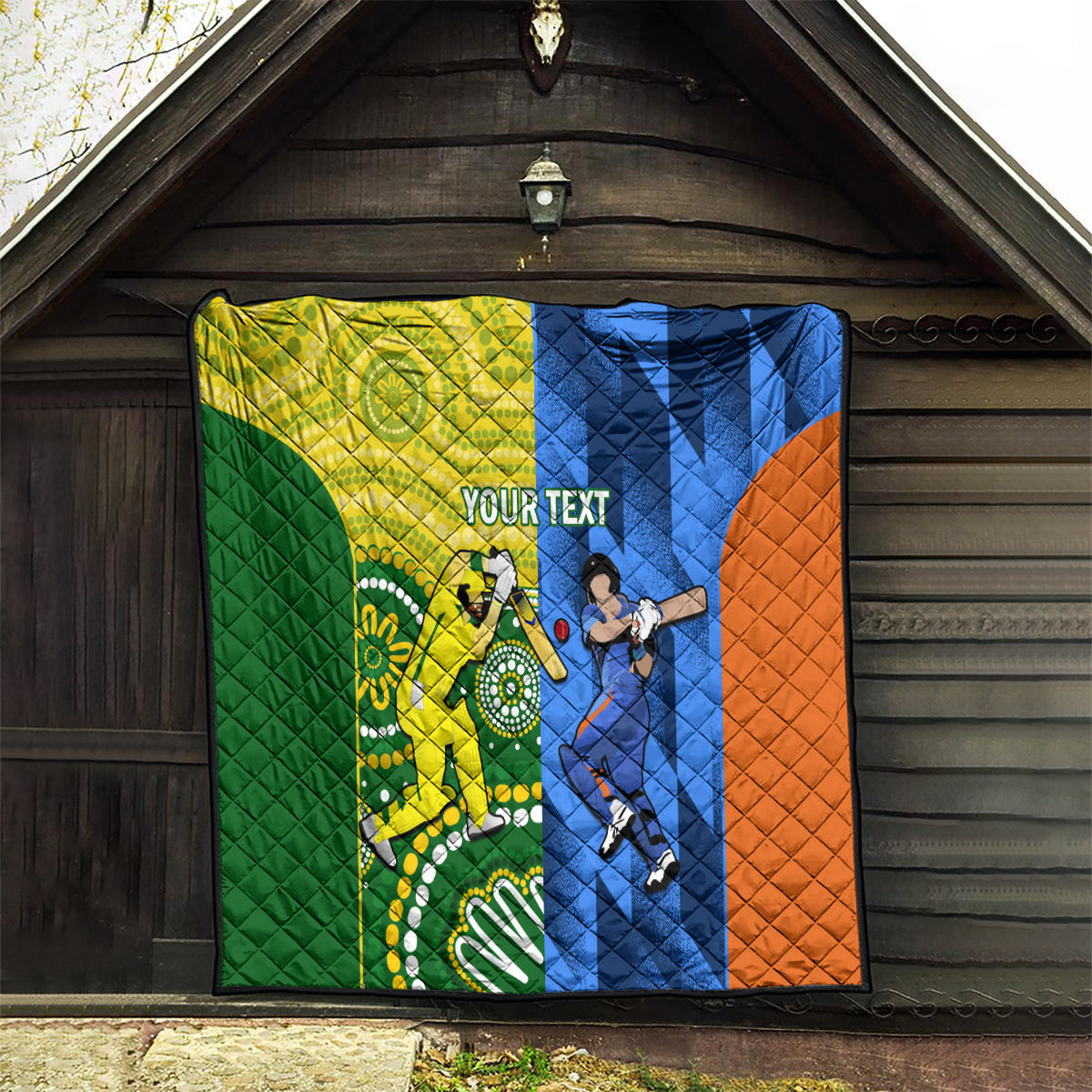Quilt blanket with green, yellow, blue, and orange cricket design and central “YOUR TEXT”