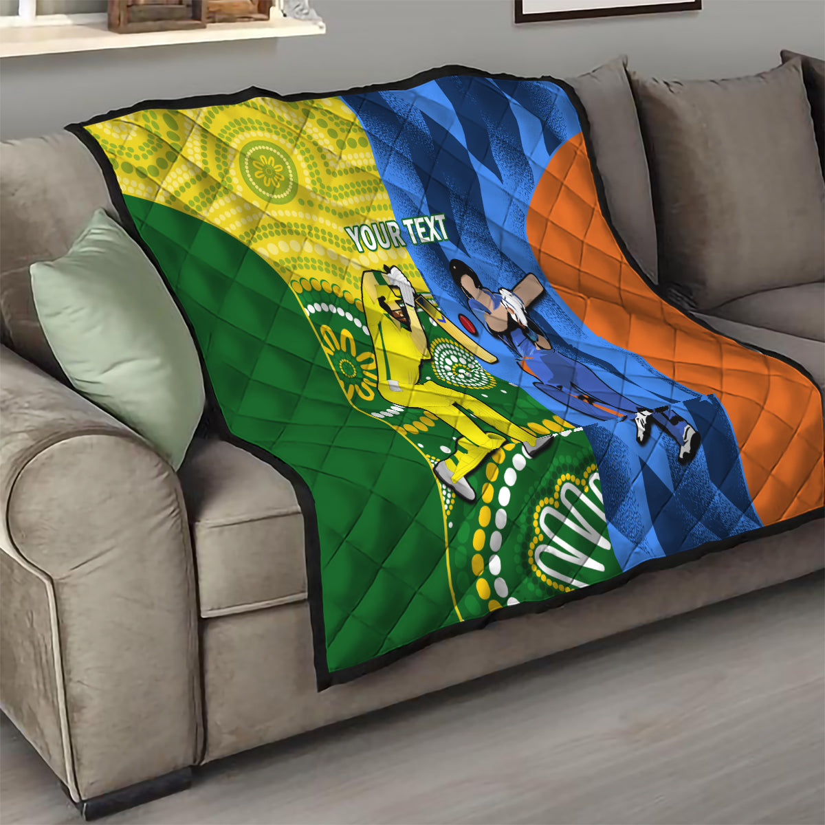 Cricket quilt blanket on gray sofa with green, yellow, blue, and orange panels and “YOUR TEXT”