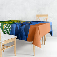 Cricket-themed tablecloth draped over wooden table, blue and green with orange edge