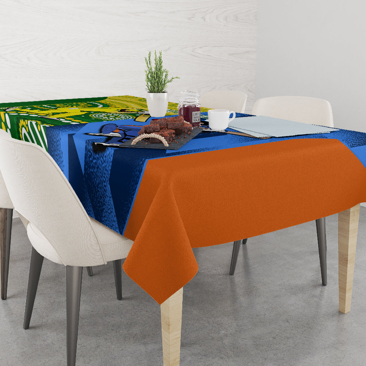 Cricket-themed tablecloth on dining table, blue, green and orange