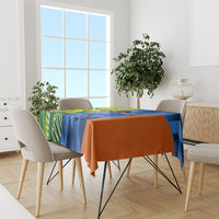 Cricket-themed tablecloth on dining table, blue and orange drape with green side