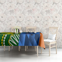 Cricket-themed tablecloth on sofa table, blue and orange with green accents