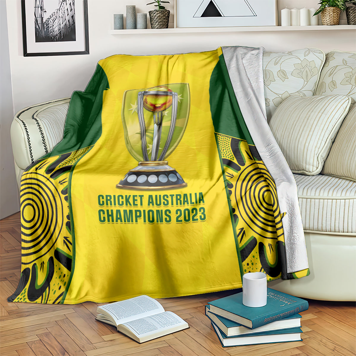 Yellow and green cricket blanket on sofa with trophy emblem and 'Cricket Australia Champions 2023'