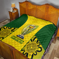 Australia cricket quilt on bed, green-and-yellow quilted chevron with trophy and text