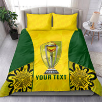 Yellow and green duvet bedding set with two pillows, central trophy emblem and "YOUR TEXT"