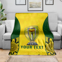 Yellow and green cricket blanket on a couch, trophy center graphic with 'YOUR TEXT'