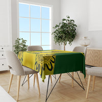 Yellow and green cricket tablecloth on dining table with flame-pattern border