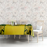 Yellow and green tablecloth with trophy and "YOUR TEXT" print on dining table