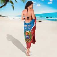 Blue and red sarong with crest and stars, worn tied at neck and waist