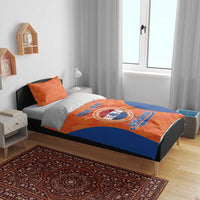 Orange and blue Netherlands bedding set on bed, duvet with “YOUR TEXT” and logo