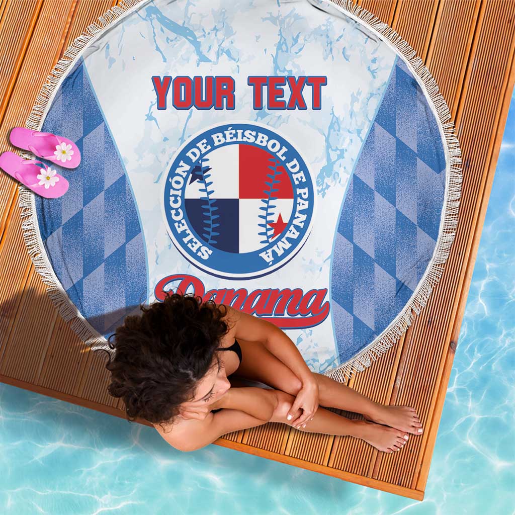 Round beach blanket with blue check pattern sides, central baseball emblem, white fringe