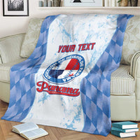 Custom baseball blanket in blue and white plaid with Panama logo, folded on couch