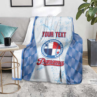 Custom baseball blanket with blue check pattern and Panama logo, draped over armchair