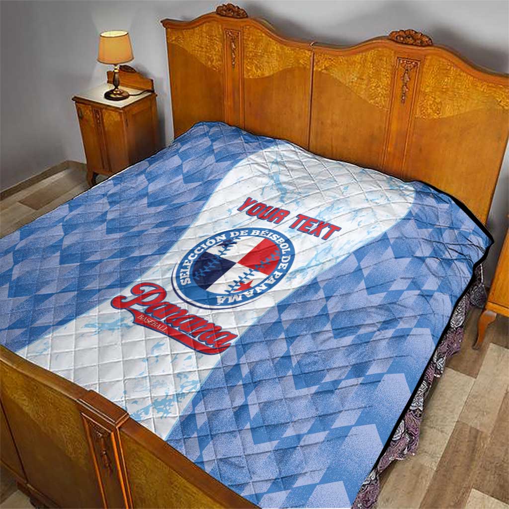Blue and white quilt with baseball-themed emblem and custom text, on a bed