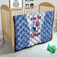 Blue and white quilt blanket with baseball emblem and custom text on a baby bed