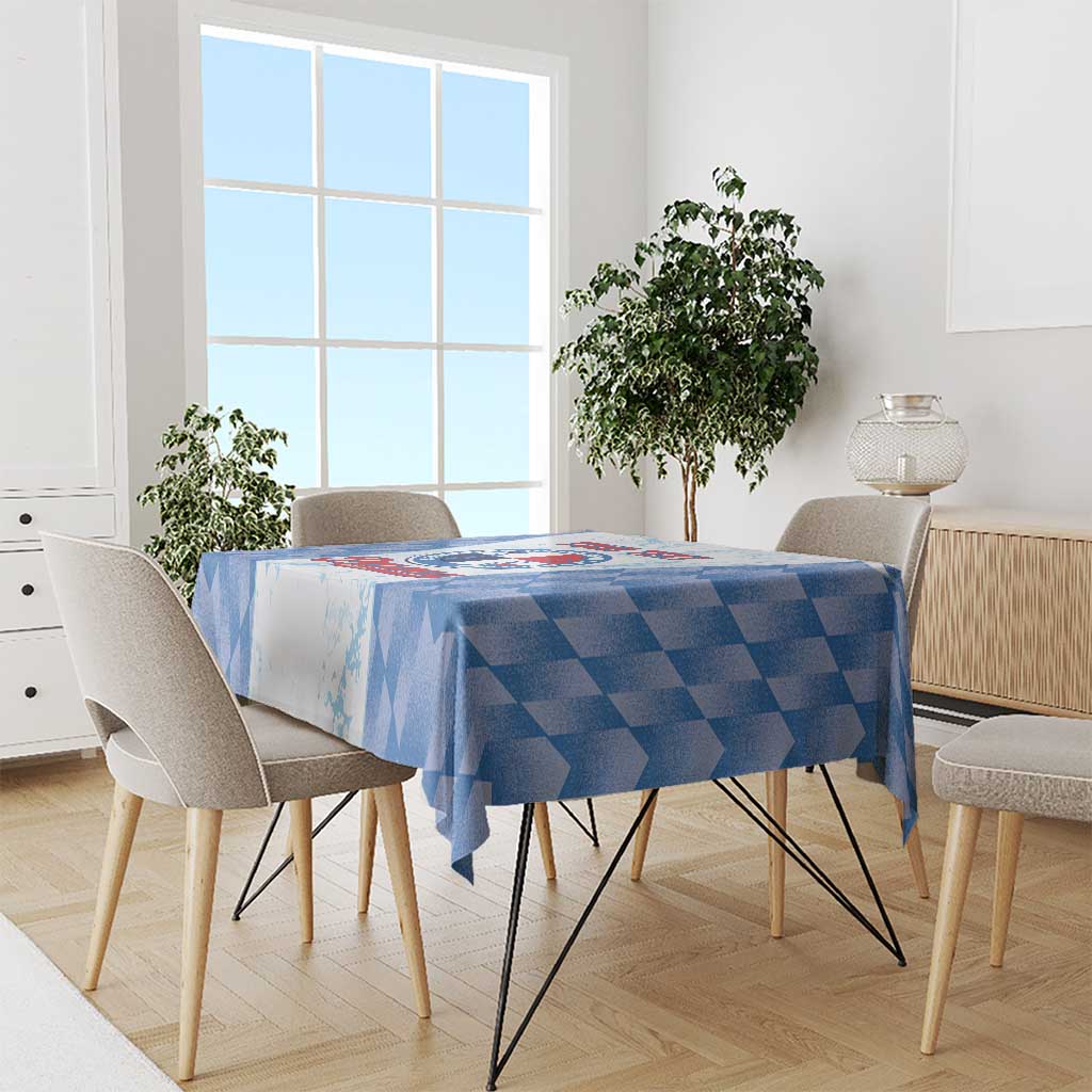 Blue checker-pattern tablecloth with draped corners on a dining table
