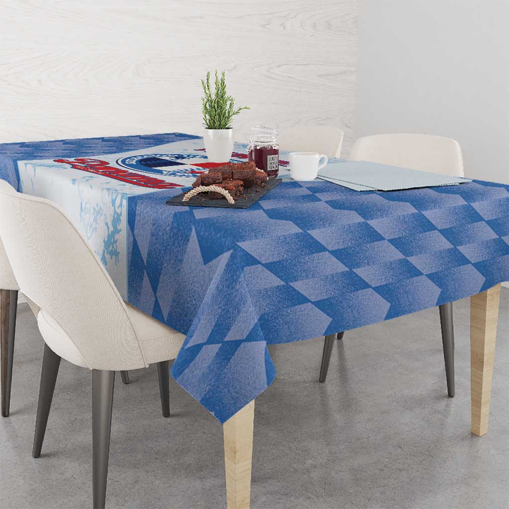 Blue checkered tablecloth with printed sports-style graphic on the table surface