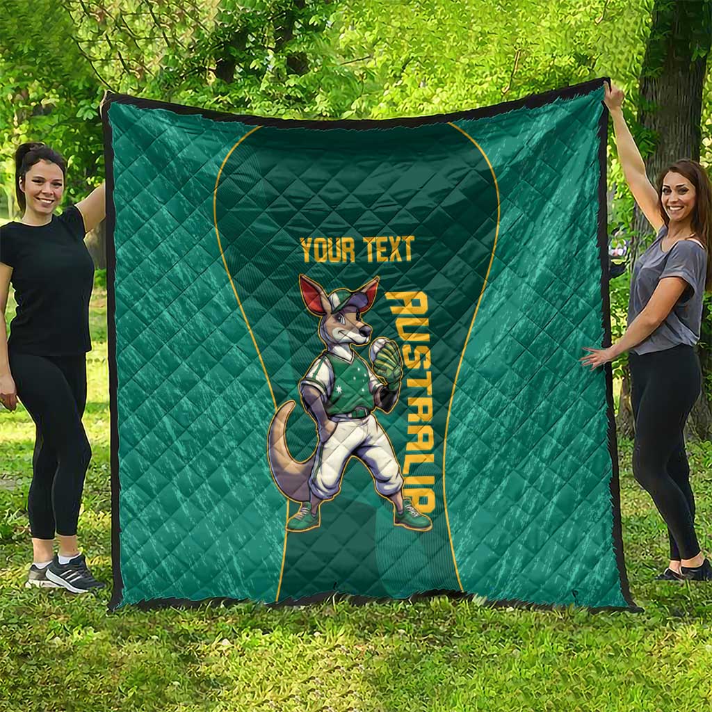Green quilt spread outdoors with kangaroo mascot and 'YOUR TEXT' title in gold