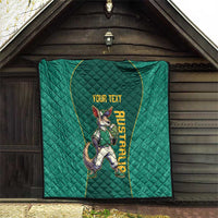Green quilt hung on porch wall, kangaroo mascot with 'YOUR TEXT' lettering