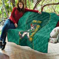 Green quilt draped on patio couch, kangaroo mascot and 'YOUR TEXT' text