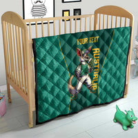 Green quilt on wooden crib with kangaroo mascot graphic and 'YOUR TEXT' wording