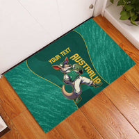 Green rubber doormat on wooden floor with kangaroo mascot and custom text layout