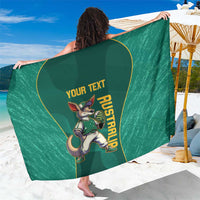 Green custom sarong with kangaroo mascot and 'YOUR TEXT' graphic, worn like a wrap