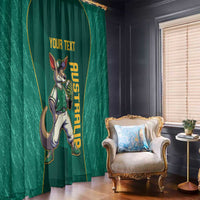 Green window curtain panel with kangaroo mascot and yellow custom text beside an armchair.