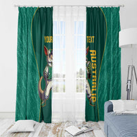 Green window curtain set with kangaroo mascot and yellow custom text hanging over window.