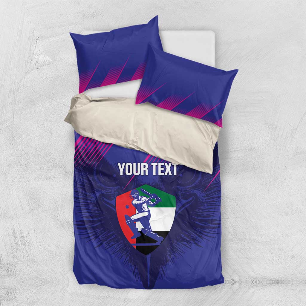 Flat-lay view of blue custom cricket duvet and pillowcases with magenta lines and shield logo.