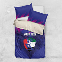 Flat-lay view of blue custom cricket duvet and pillowcases with magenta lines and shield logo.