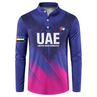 Blue henley sweatshirt with UAE crest, eagle-wing print, and pink geometric hem panel