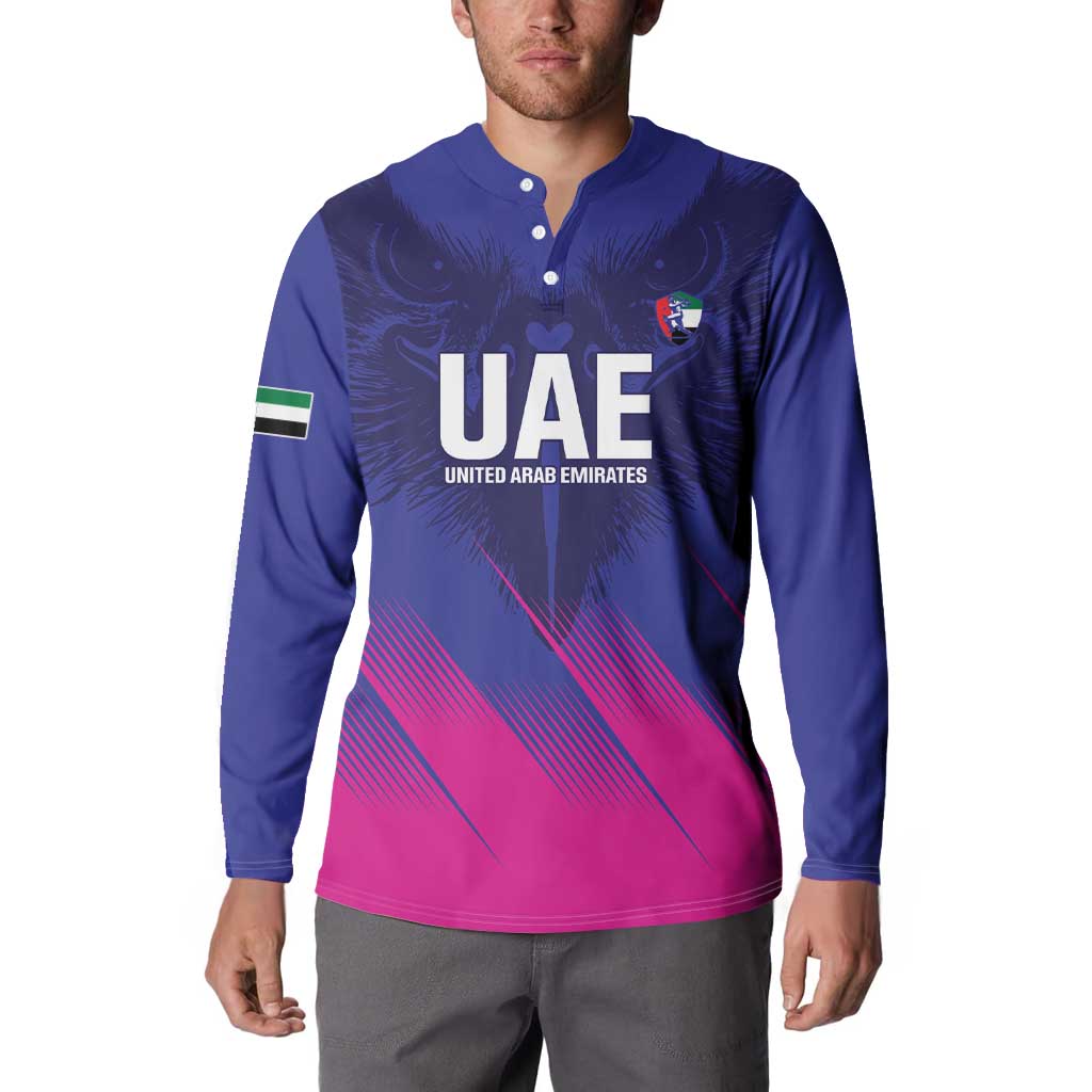 Blue henley sweatshirt with UAE crest, eagle wings, and pink diagonal stripe hem