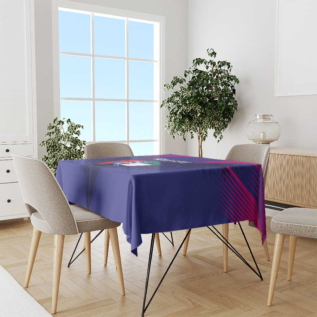 Blue tablecloth with printed sports graphic, draped on dining table with chairs