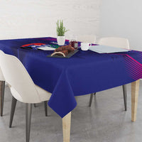 Blue tablecloth with diagonal stripe print and sports motif, laid across dining table