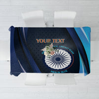 Blue cricket tablecloth flat lay with central circular logo and teal diagonal accents.