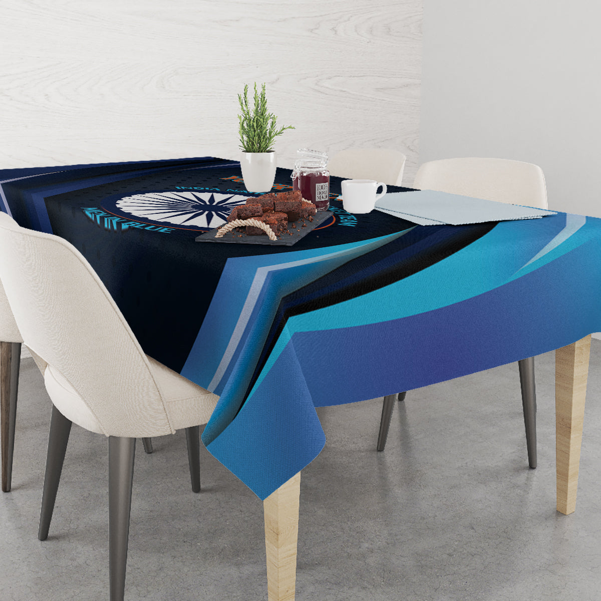 Blue cricket tablecloth with dark navy and teal stripes and central circular logo.
