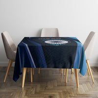 Blue cricket tablecloth with dark navy pattern and teal stripe border over dining table.