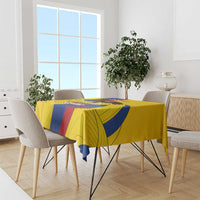 Yellow tablecloth with blue and red diagonal stripes and bold eagle-style artwork